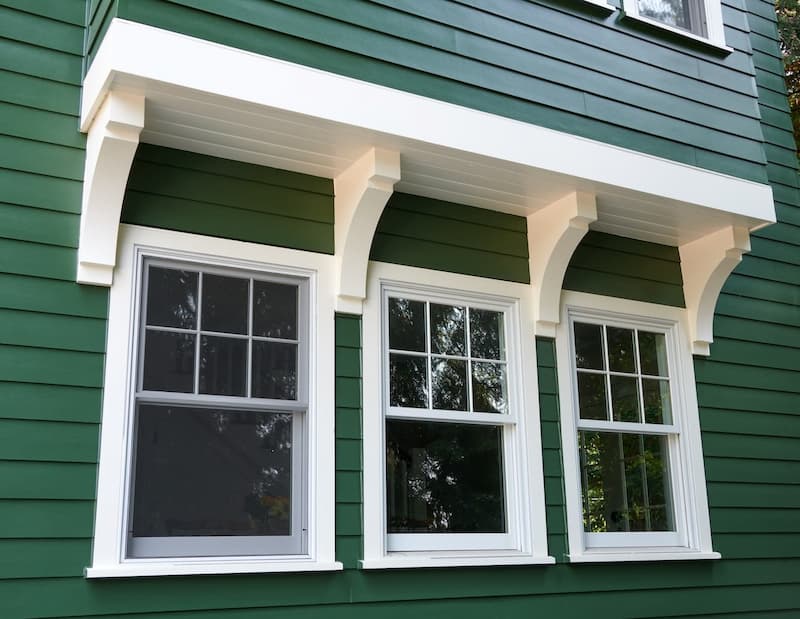 Green house with white trim