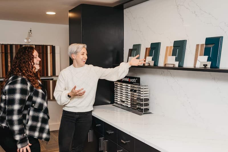 Two women meeting to review kitchen details.