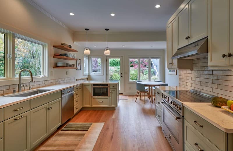 Remodeled kitchen with open shelves and two pendant lights