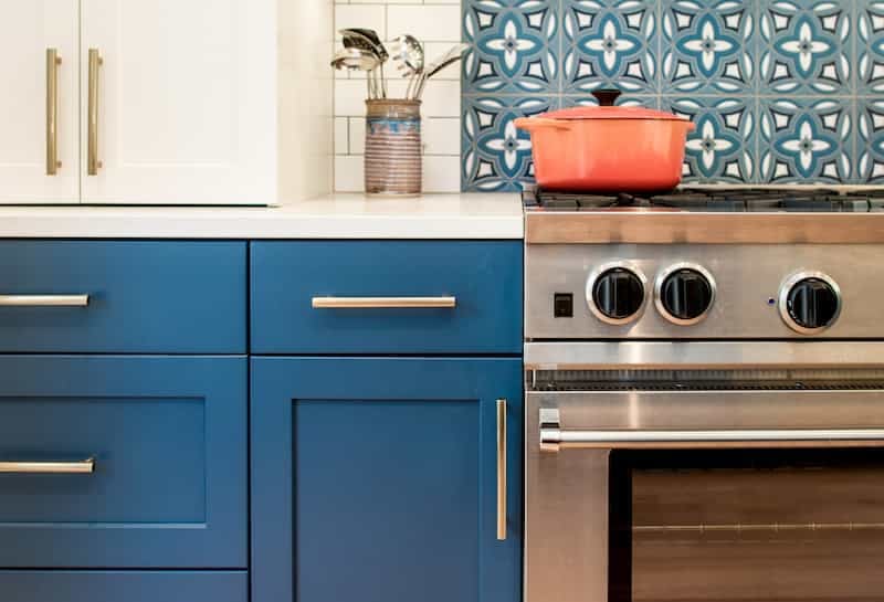 Remodeled Seattle kitchen with blue cabinets and patterned tile backsplash