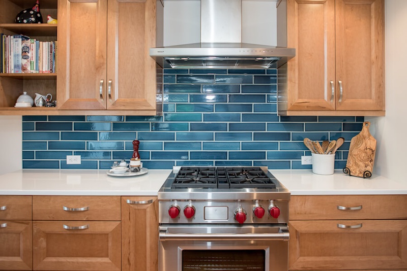 Remodeled Seattle kitchen with professional range and blue tile backsplash