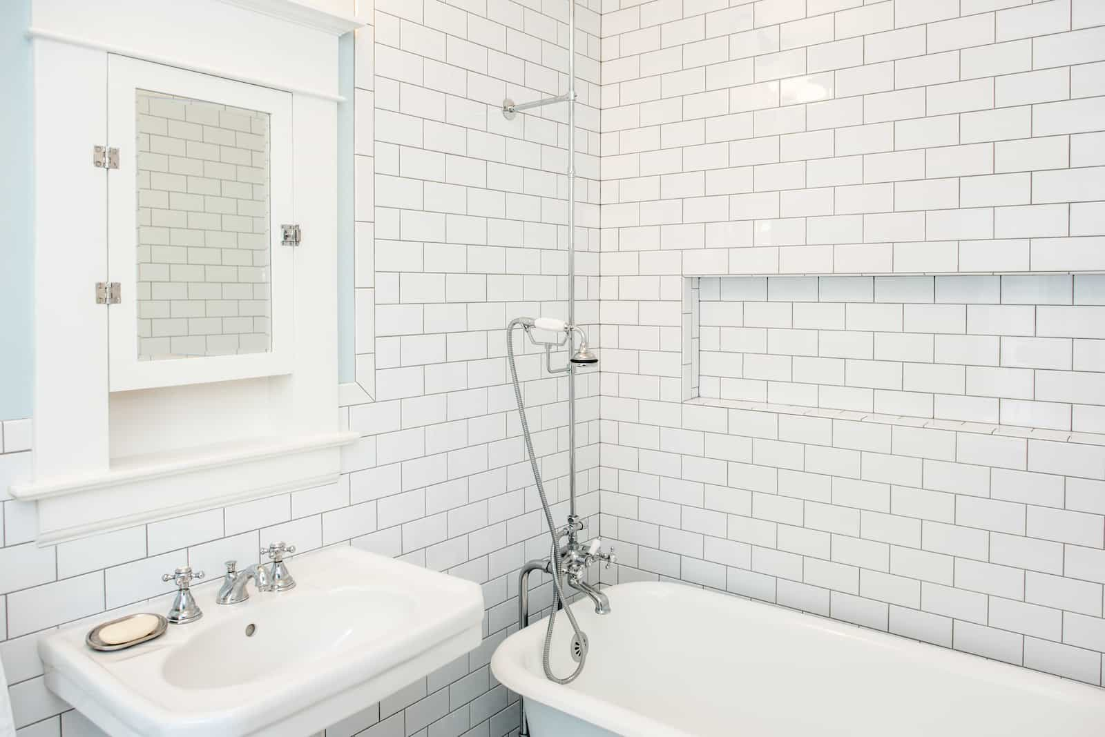 Photo of small full bathroom with door on long wall