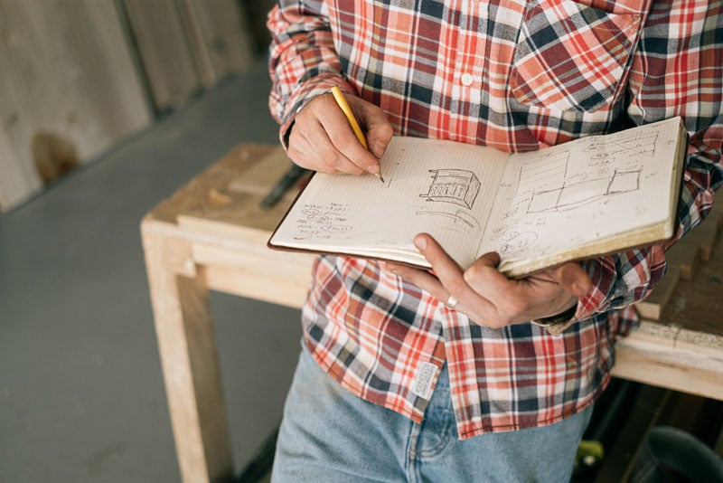 Carpenter drawing furniture sketches