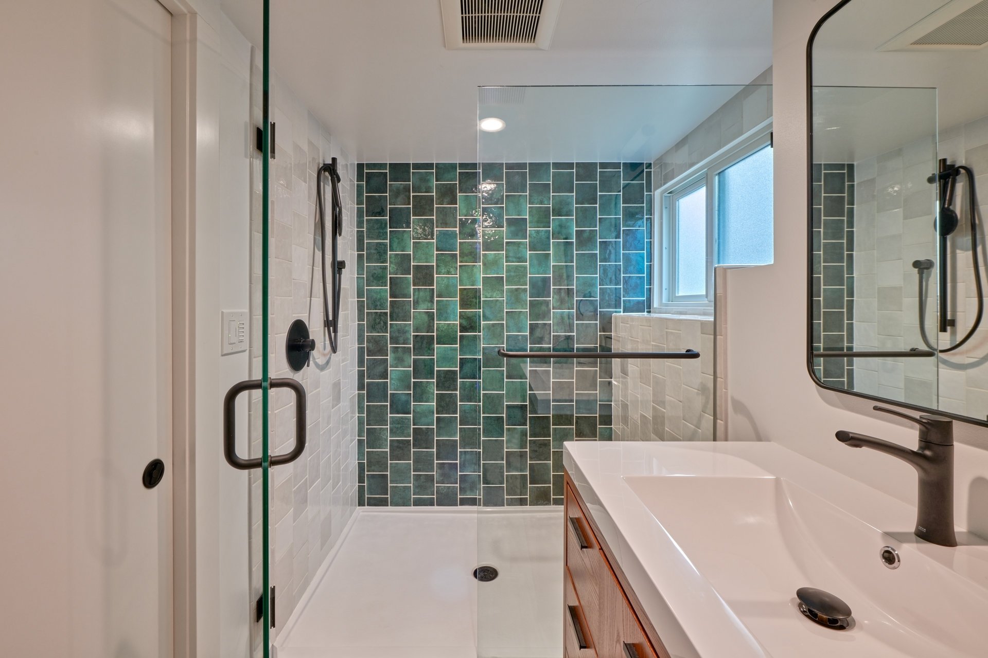 Remodeled Fremont bathroom with green tile in shower
